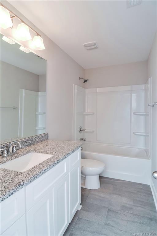 1338 Armstrong Road Belmont, NC 28012 - Photo 13 of 14 a bathroom with a granite countertop sink a toilet and bathtub