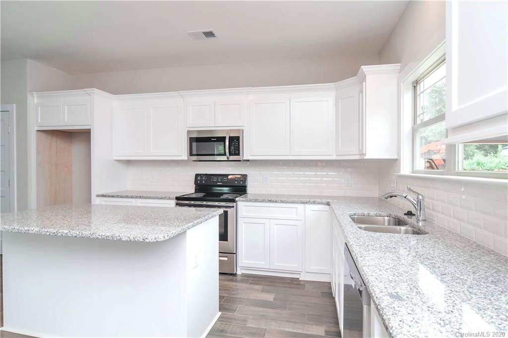 1338 Armstrong Road Belmont, NC 28012 - Photo 3 of 14 a kitchen with a sink stove top oven and microwave