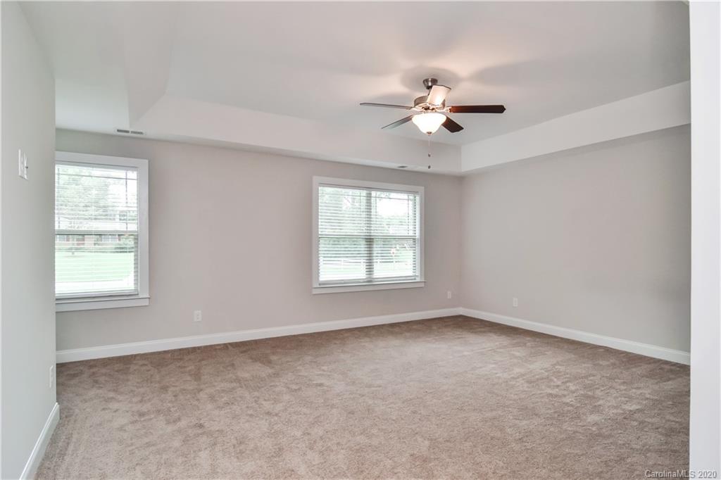 1338 Armstrong Road Belmont, NC 28012 - Photo 8 of 14 an empty room with windows and chandelier fan