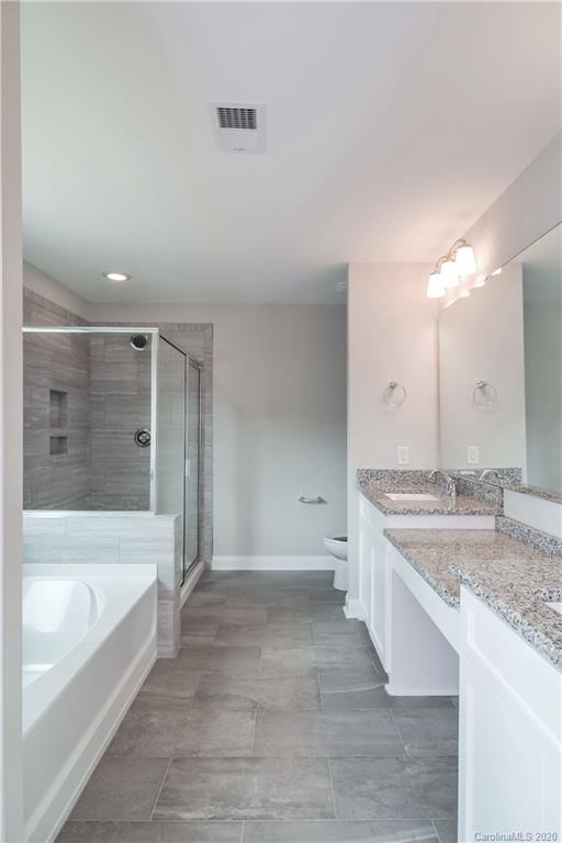 1338 Armstrong Road Belmont, NC 28012 - Photo 9 of 14 a bathroom with a granite countertop sink a toilet and bathtub