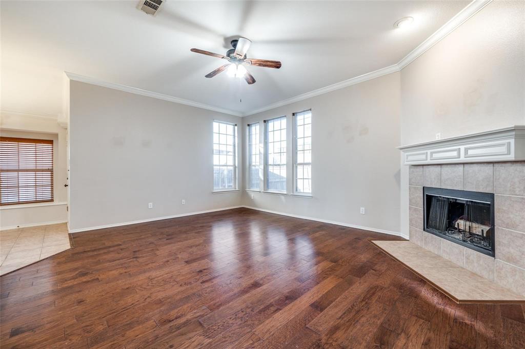 6752 Longhorn Trail Frisco, TX 75034 - Photo 4 of 12 a view of an empty room with exposed radiator and fireplace