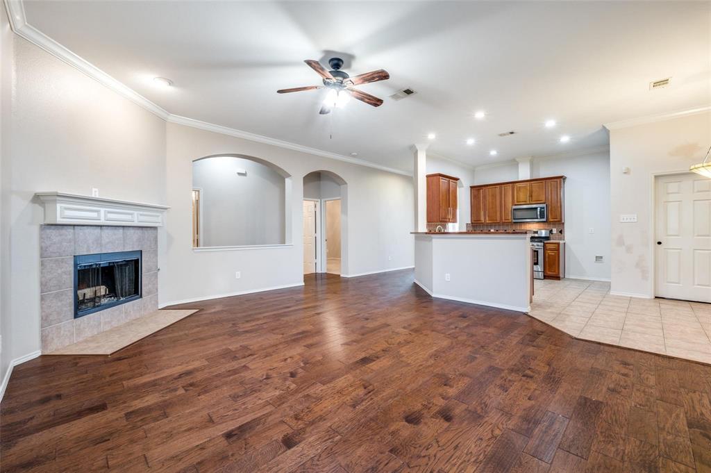 6752 Longhorn Trail Frisco, TX 75034 - Photo 5 of 12 a view of a kitchen with a sink and a fireplace