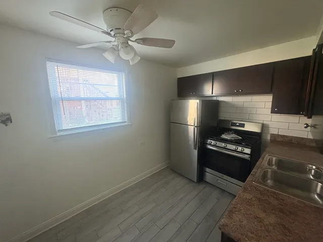 a kitchen with wooden cabinets and stainless steel appliances