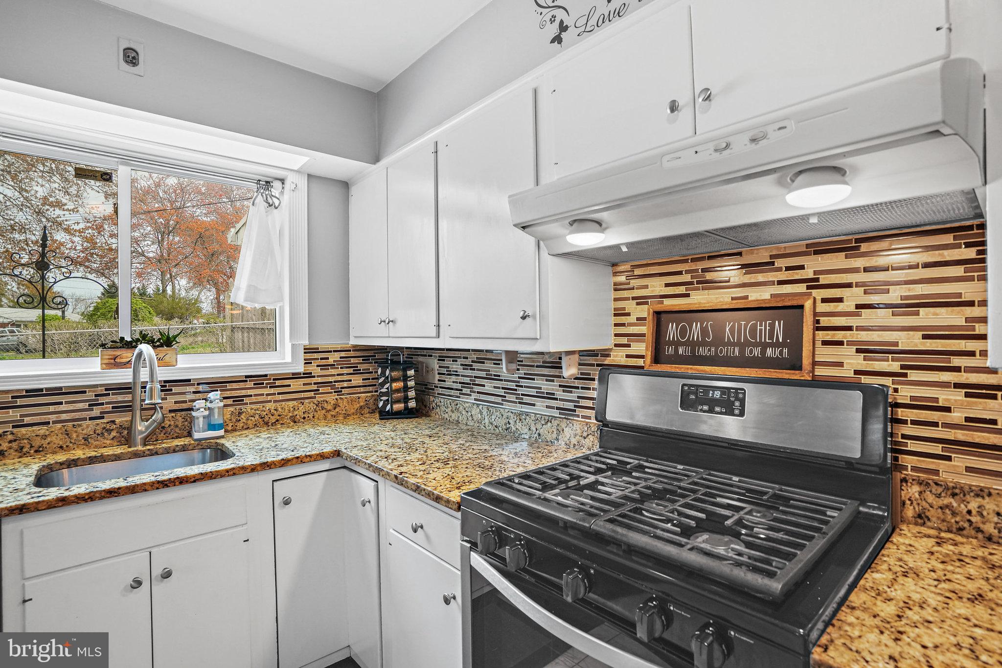 3816 Kayson Street Silver Spring, MD 20906 - Photo 16 of 44 a kitchen with a stove a sink and a counter space