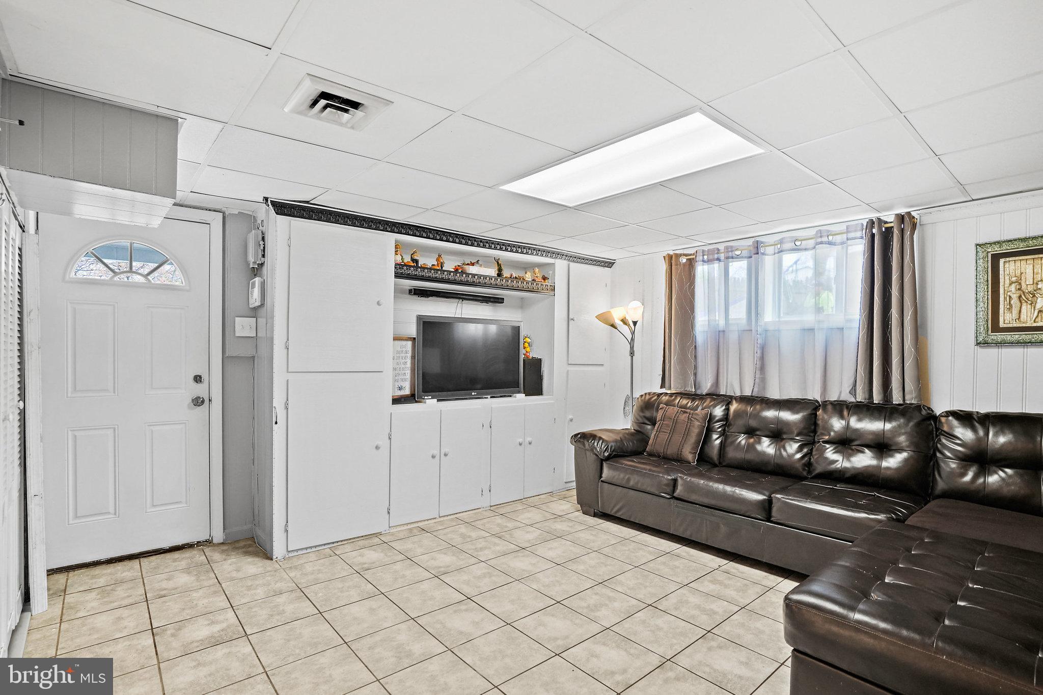 3816 Kayson Street Silver Spring, MD 20906 - Photo 19 of 44 a living room with furniture and a flat screen tv