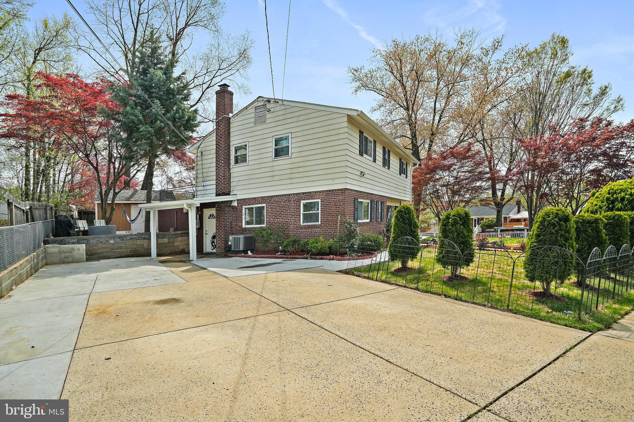 3816 Kayson Street Silver Spring, MD 20906 - Photo 2 of 44 a front view of a house with a yard and trees