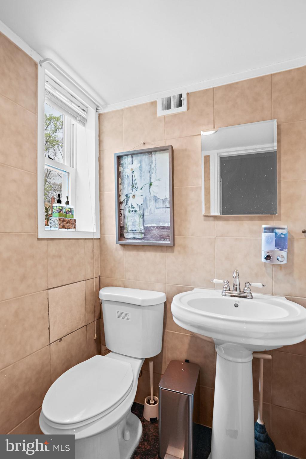 3816 Kayson Street Silver Spring, MD 20906 - Photo 21 of 44 a bathroom with a toilet a sink and mirror