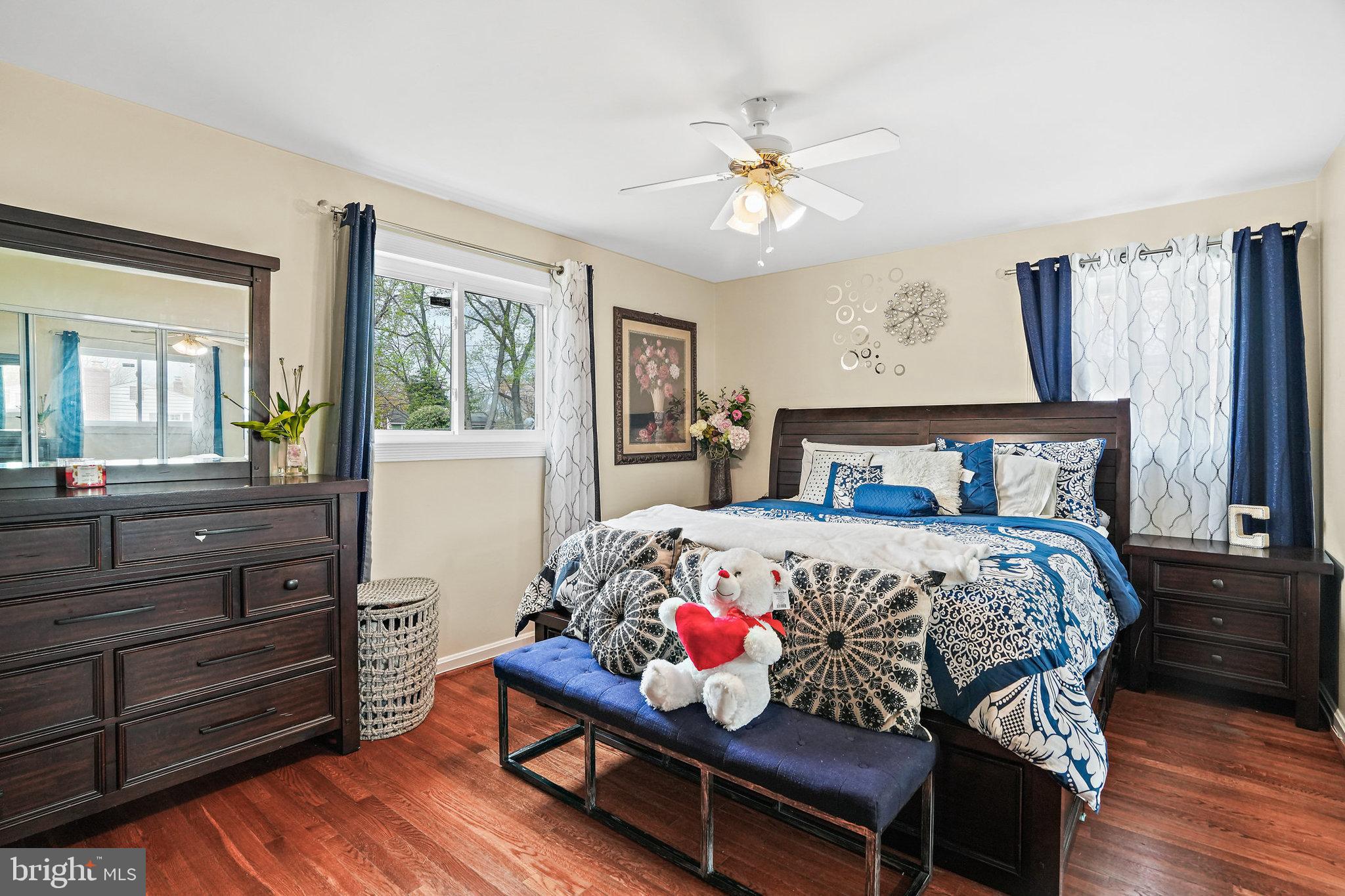 3816 Kayson Street Silver Spring, MD 20906 - Photo 22 of 44 a bedroom with a bed and wooden floor