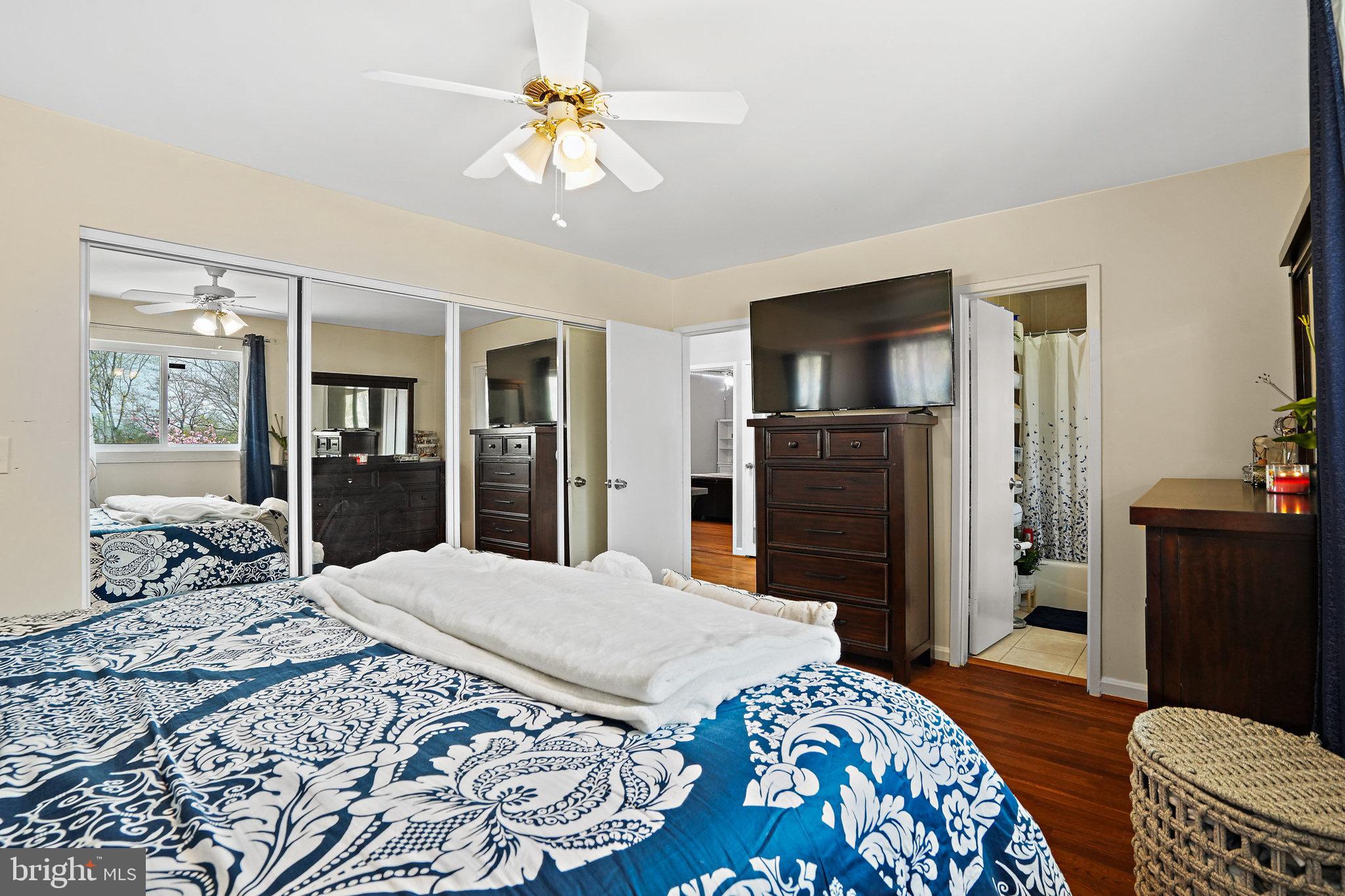3816 Kayson Street Silver Spring, MD 20906 - Photo 23 of 44 a bedroom with a bed and dresser with mirror