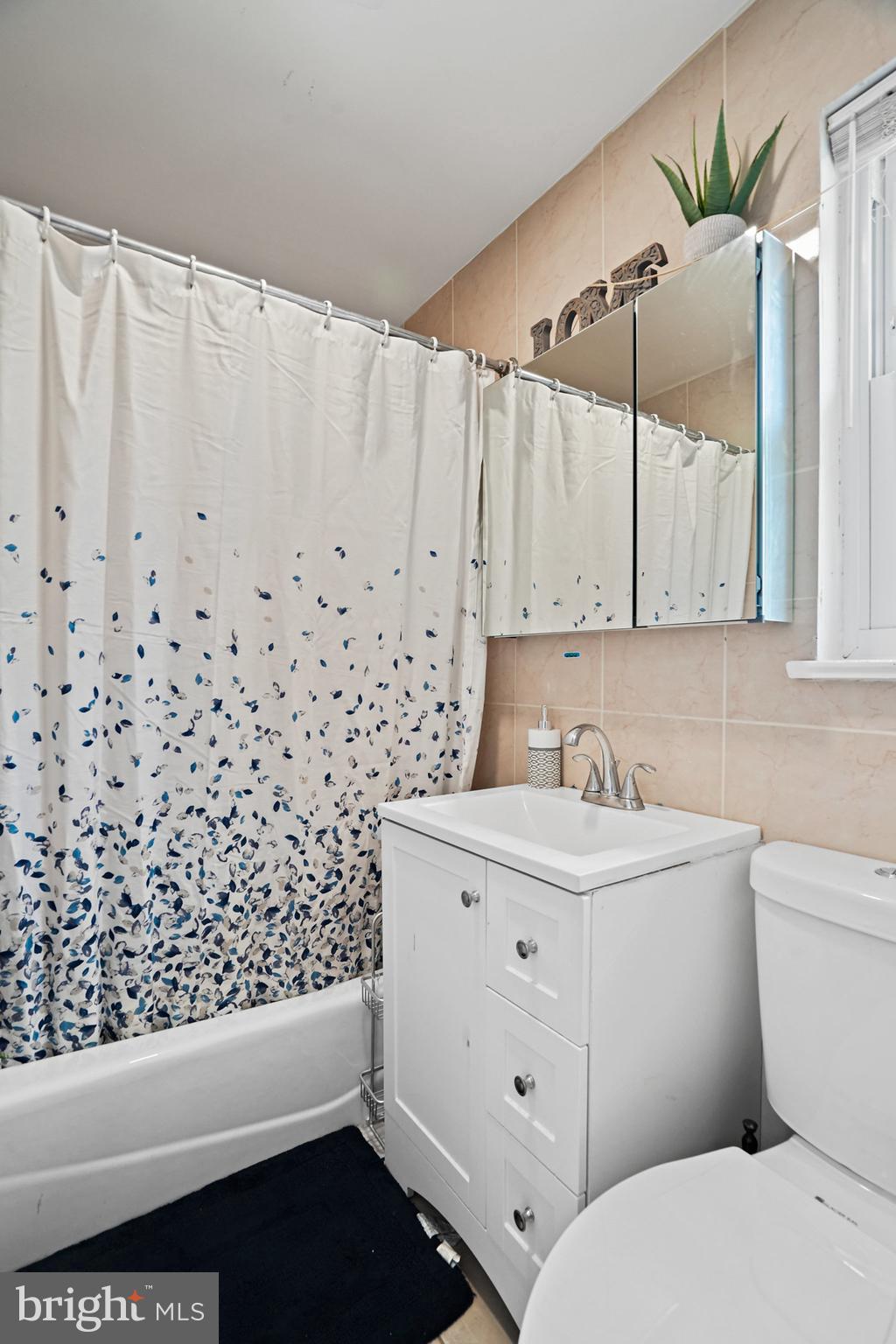 3816 Kayson Street Silver Spring, MD 20906 - Photo 25 of 44 a bathroom with a sink a toilet and a window