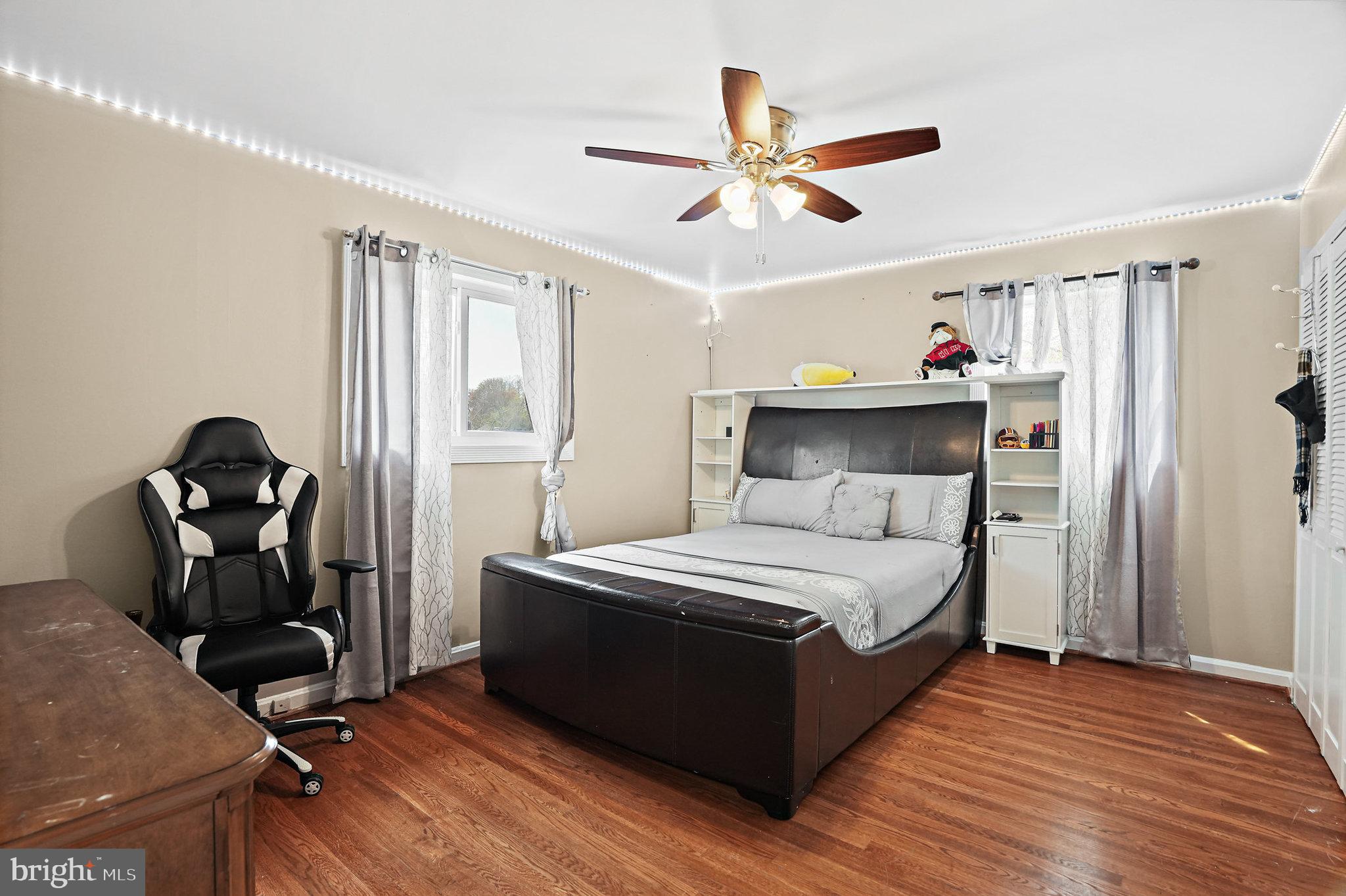 3816 Kayson Street Silver Spring, MD 20906 - Photo 30 of 44 a bedroom with a bed and wooden floor