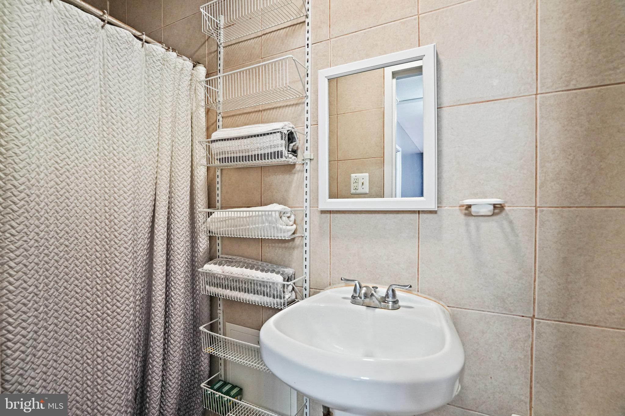 3816 Kayson Street Silver Spring, MD 20906 - Photo 32 of 44 a bathroom with a sink a toilet and shower