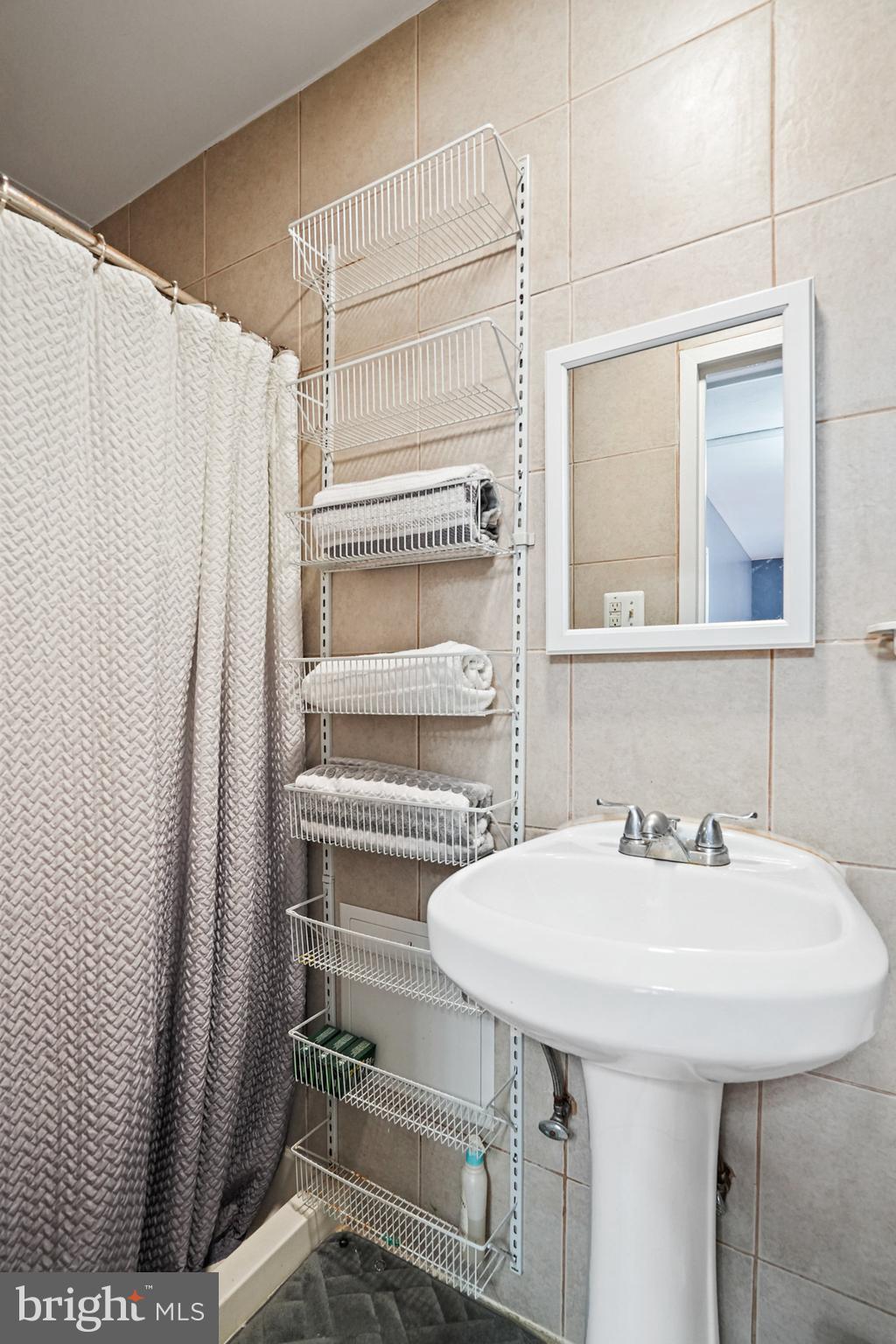 3816 Kayson Street Silver Spring, MD 20906 - Photo 33 of 44 a bathroom with a sink and a mirror