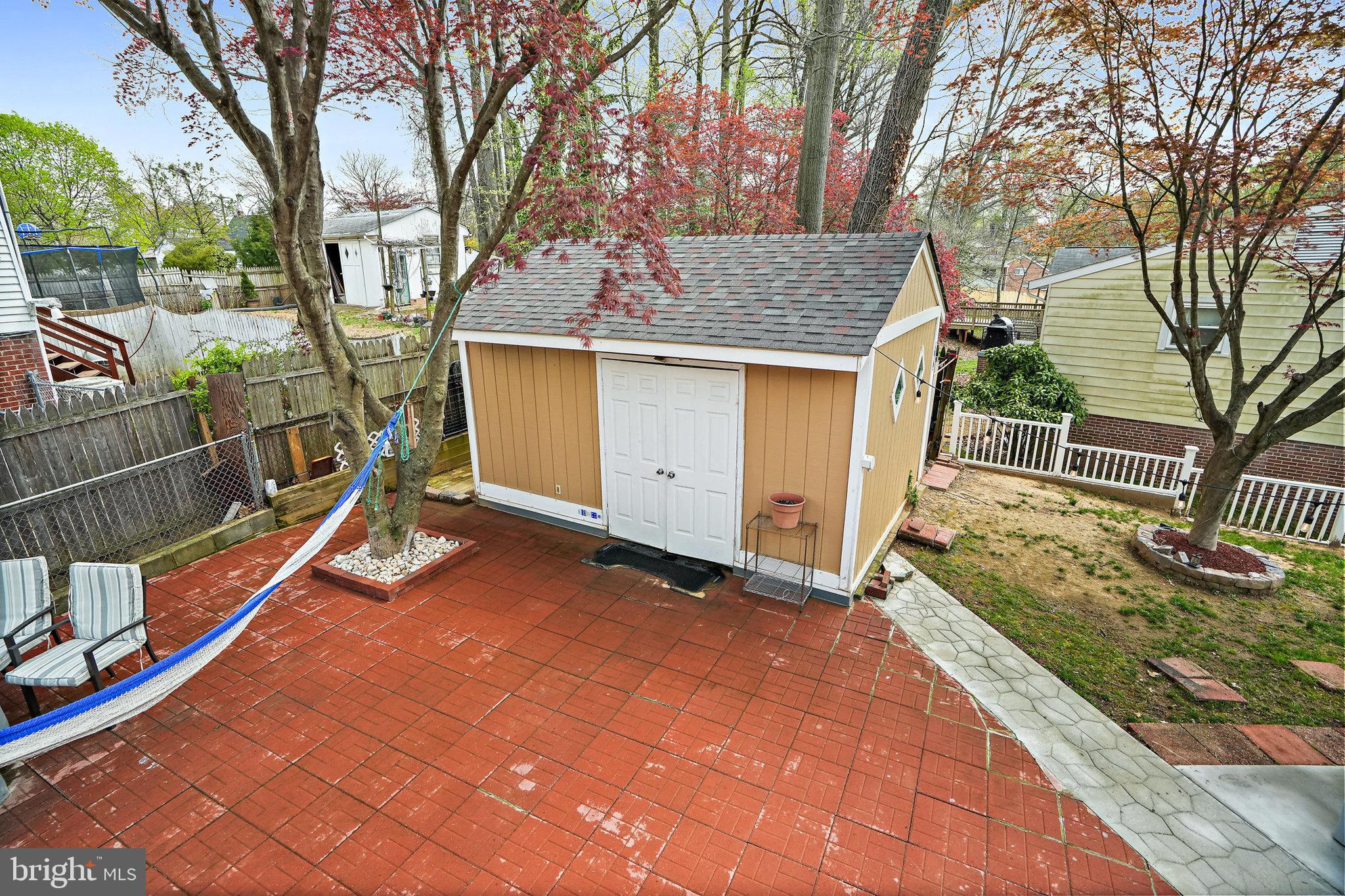 3816 Kayson Street Silver Spring, MD 20906 - Photo 37 of 44 a view of a house with a wooden deck and a large tree