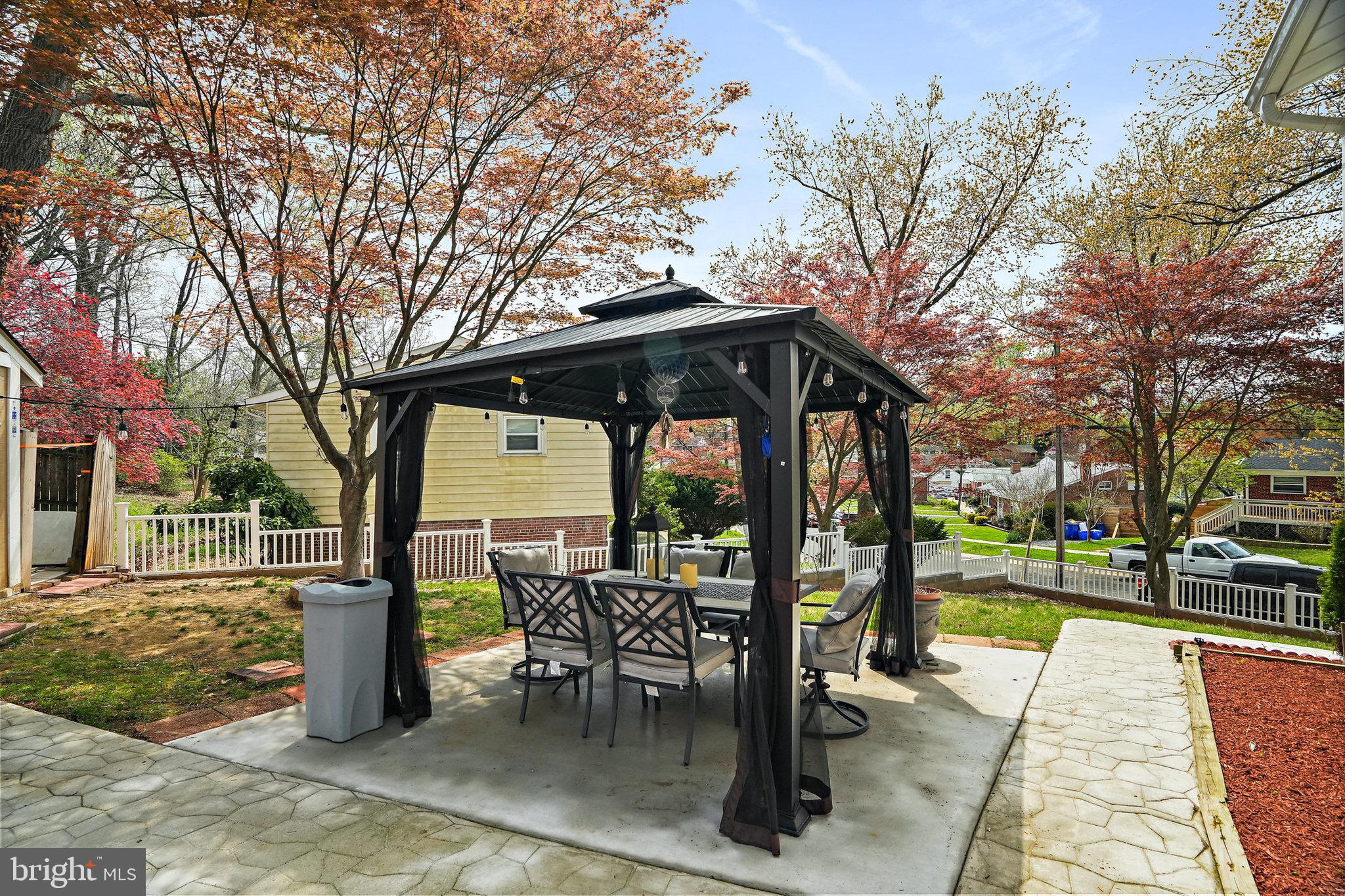 3816 Kayson Street Silver Spring, MD 20906 - Photo 38 of 44 a view of a patio with table and chairs and floor to ceiling window