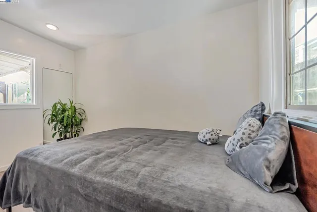 a bedroom with a bed and a window