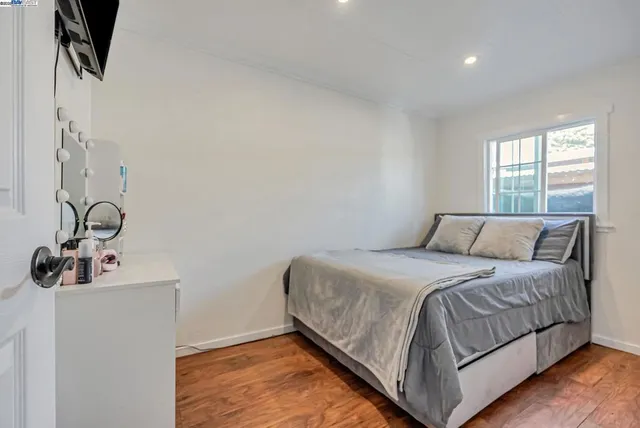 a bedroom with a bed and window