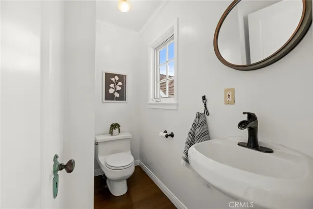 a kitchen with stainless steel appliances a refrigerator a sink and wooden cabinets