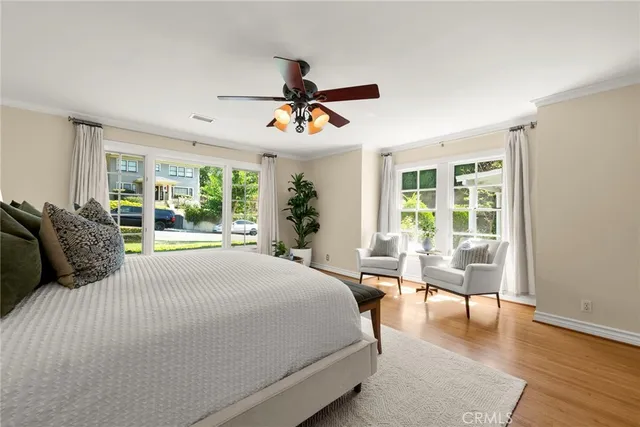 a bedroom with a bed and a table in it with window