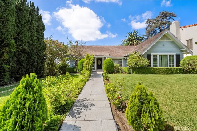 a front view of house with yard and green space