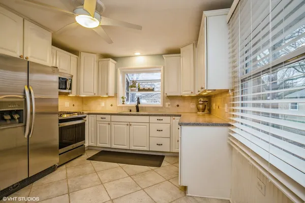 a kitchen with granite countertop cabinets stainless steel appliances a sink and a counter top space