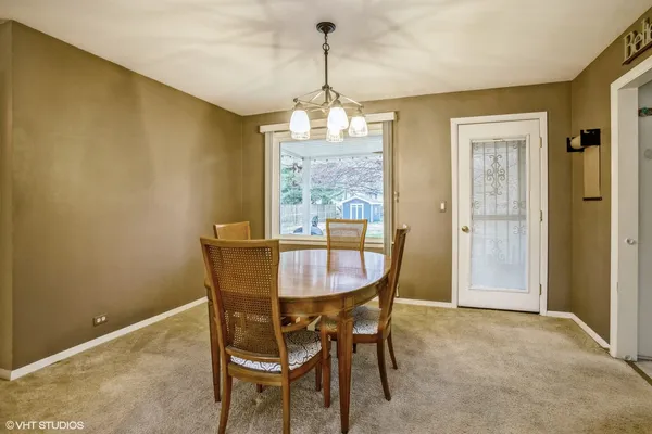 a dining room with furniture and window