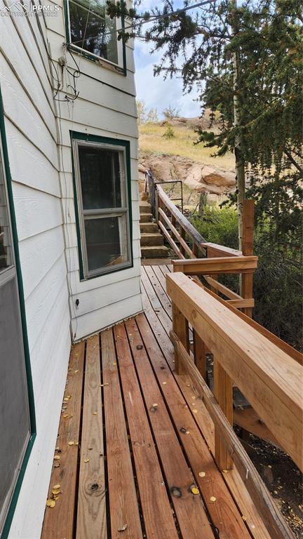 210 7th Street Victor, CO 80860 - Photo 16 of 24 a view of a balcony with wooden floor and outdoor space