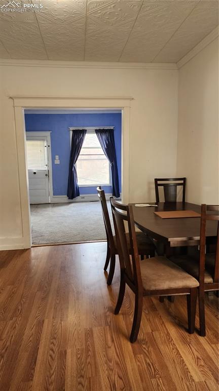 210 7th Street Victor, CO 80860 - Photo 9 of 24 a view of a dining room with furniture and wooden floor