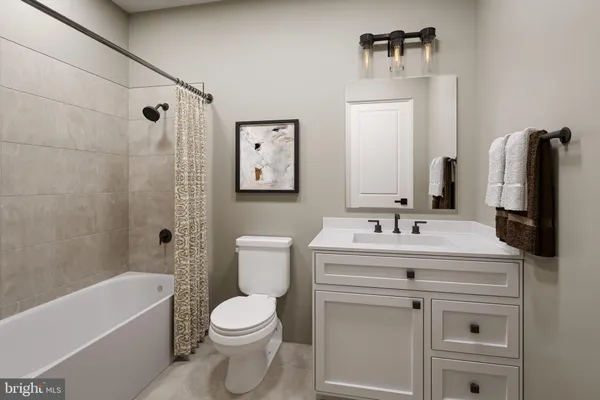 a bathroom with a sink toilet tub and shower