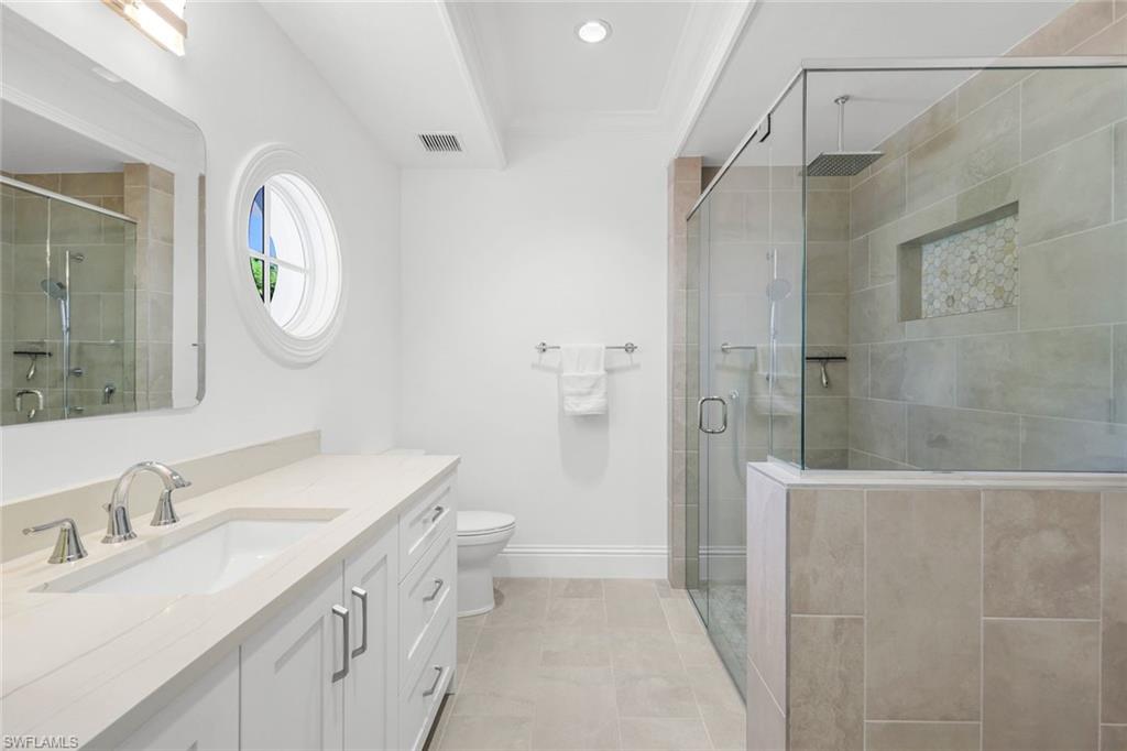 400 Springline Drive Naples, FL 34102 - Photo 31 of 37 Bathroom with vanity, a stall shower, light tile patterned flooring, ornamental molding, and recessed lighting
