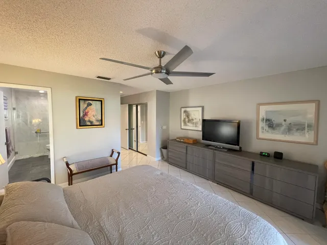 a spacious bedroom with a bed and window