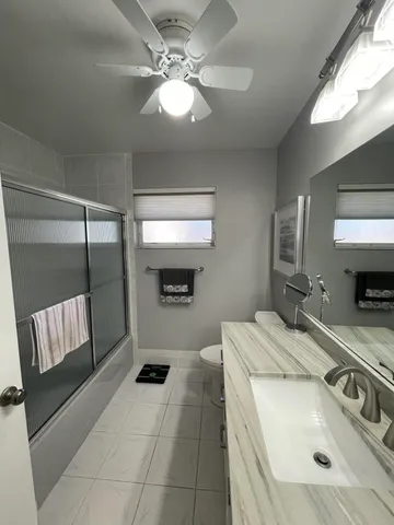 a view of a house with backyard sitting area and garden