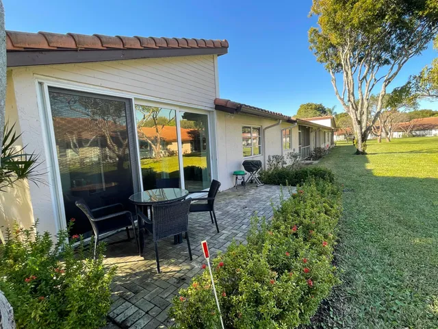 a view of a backyard with potted plants