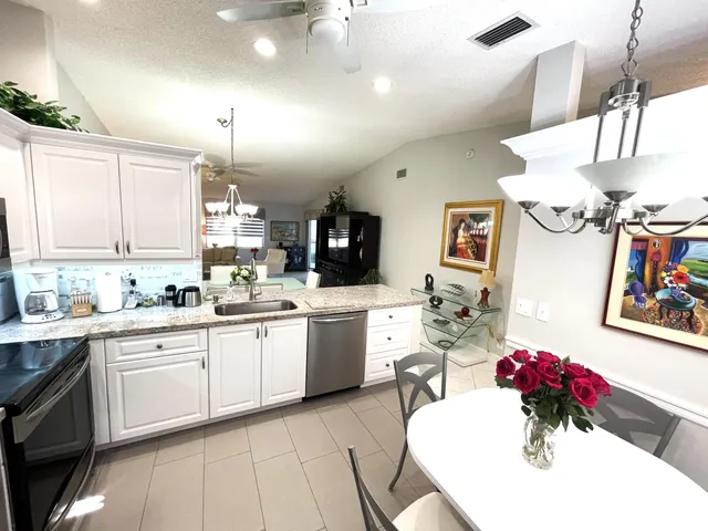a kitchen with a sink and white cabinets