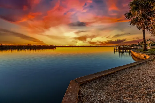 a view of a dining room with furniture a chandelier and wooden floor