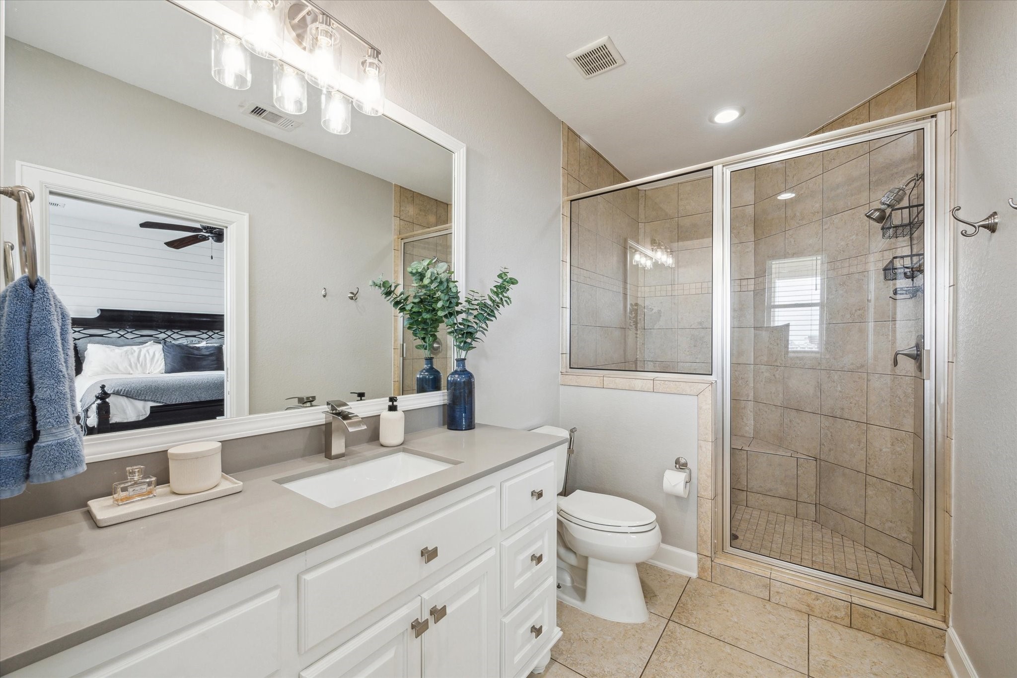 7 Ramrod Hitchcock, TX 77563 - Photo 21 of 41 a bathroom with a granite countertop sink a toilet a large mirror and shower