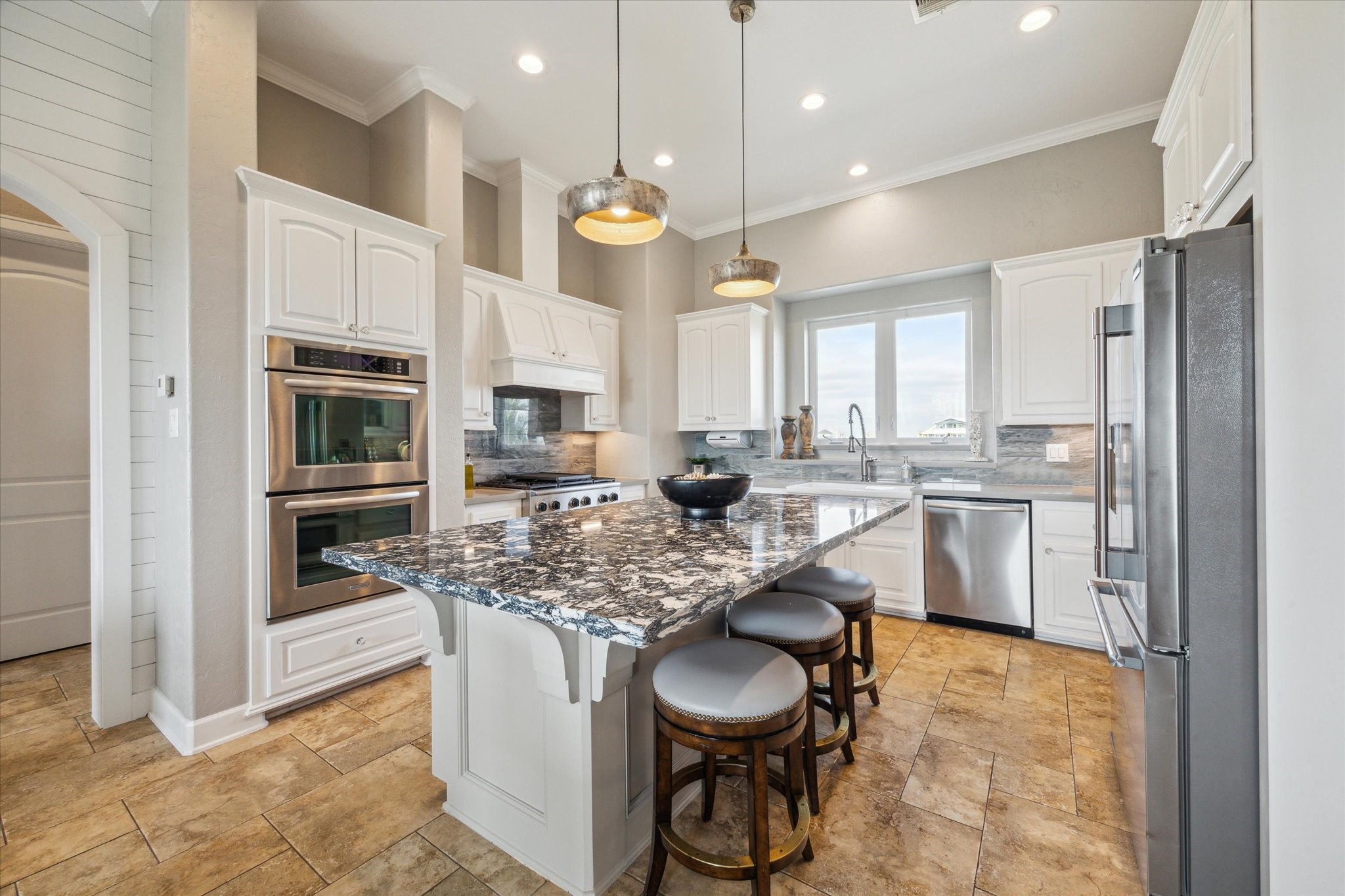 7 Ramrod Hitchcock, TX 77563 - Photo 9 of 41 a kitchen with stainless steel appliances granite countertop a stove a sink a oven a dining table and chairs