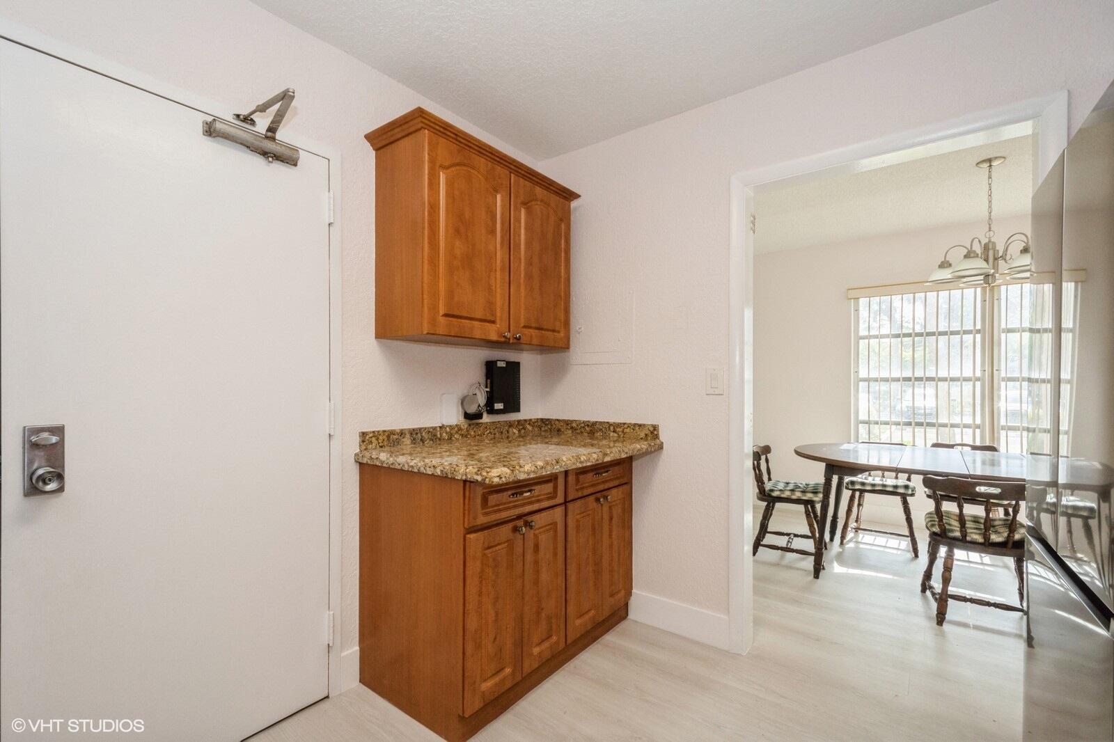 10777 West Sample Road, Unit 101 Coral Springs, FL 33065 - Photo 12 of 36 a view of a kitchen with furniture and window