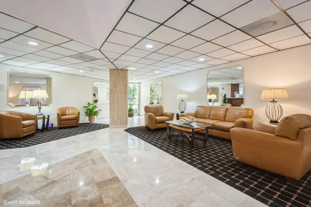a living room with furniture a couch and chandelier