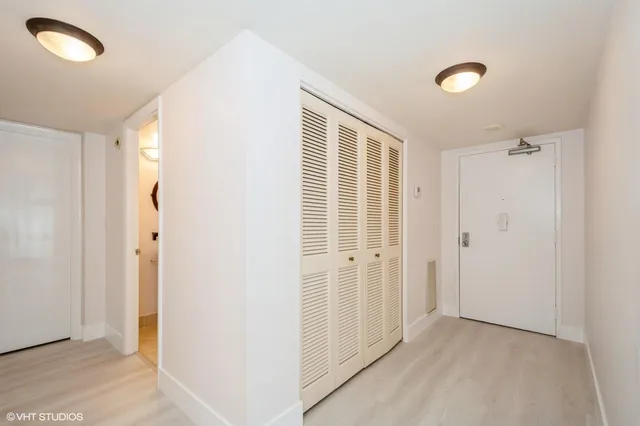 a view of a livingroom with wooden floor and cabinet