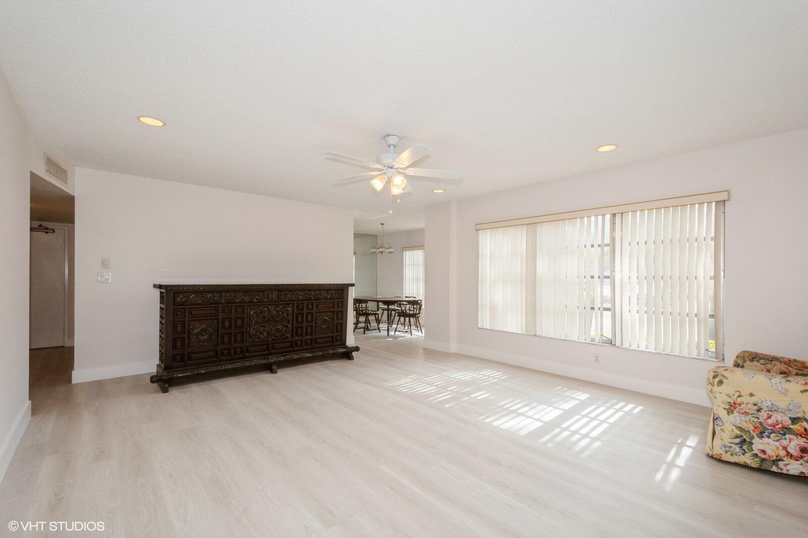 10777 West Sample Road, Unit 101 Coral Springs, FL 33065 - Photo 7 of 36 a living room with furniture and a window