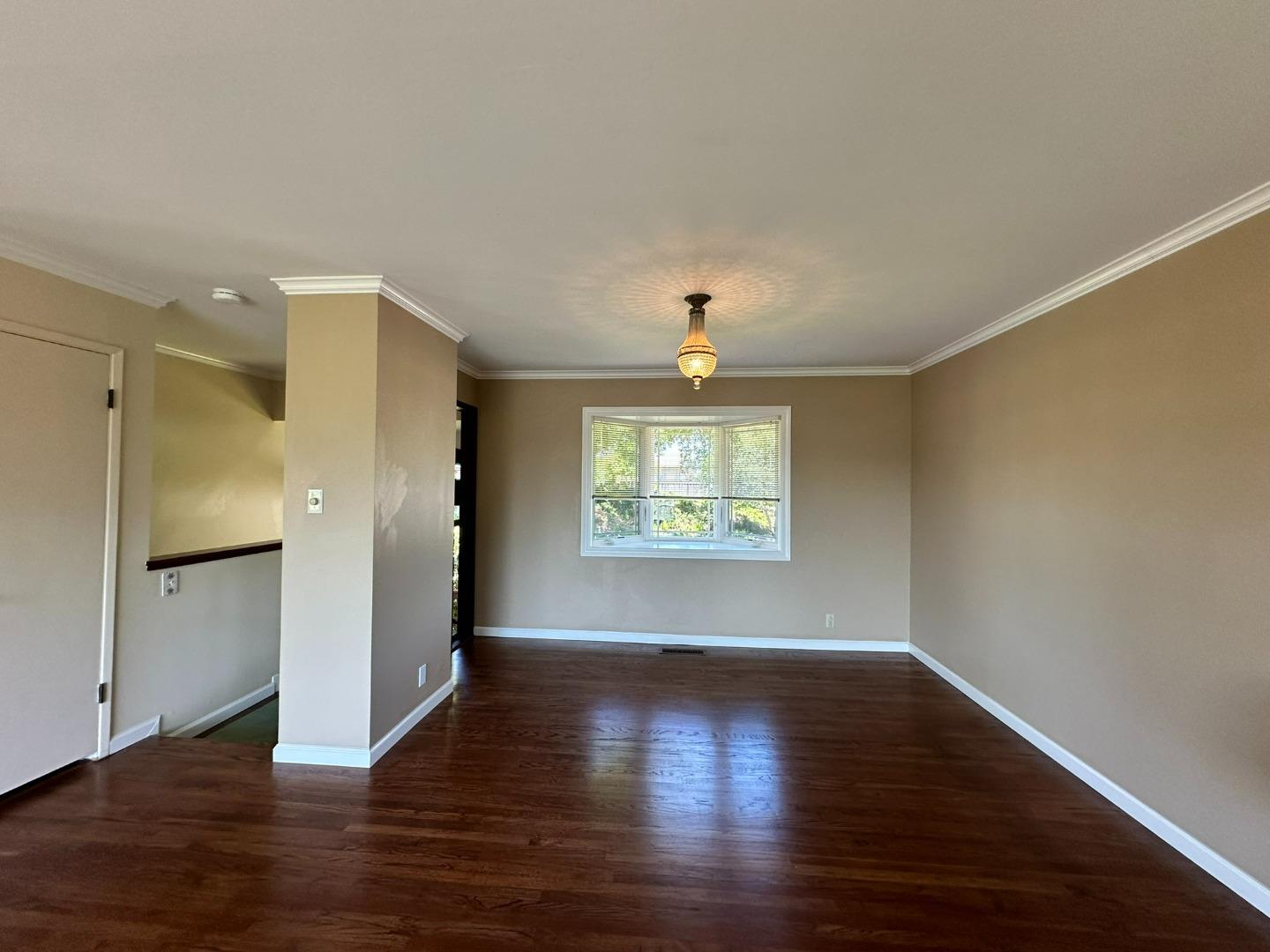 46 Arch Lane San Carlos, CA 94070 - Photo 6 of 22 a view of an empty room with wooden floor and a window