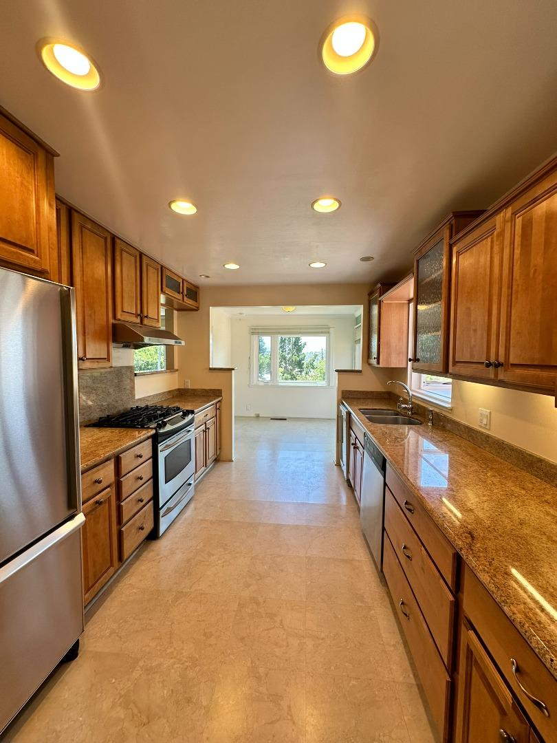 46 Arch Lane San Carlos, CA 94070 - Photo 9 of 22 a kitchen with stainless steel appliances granite countertop a refrigerator and a stove top oven