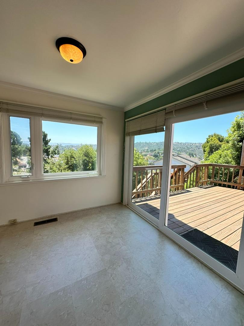 46 Arch Lane San Carlos, CA 94070 - Photo 10 of 22 an empty room with wooden floor and windows
