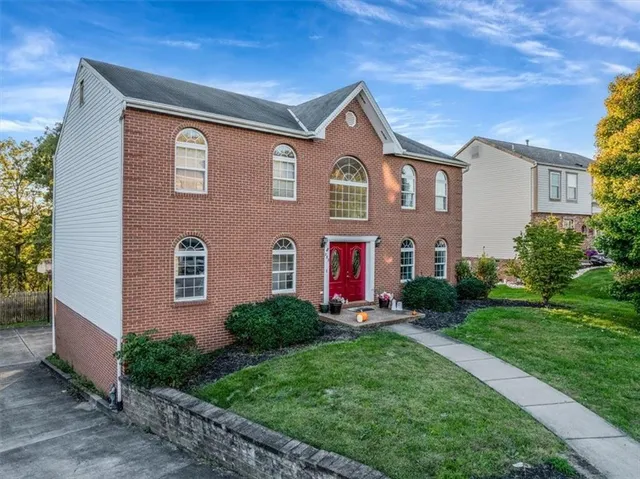 a front view of a house with a yard