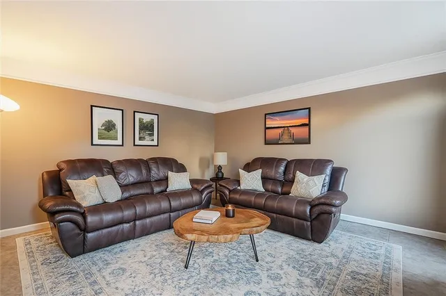 a living room with furniture a rug and a window