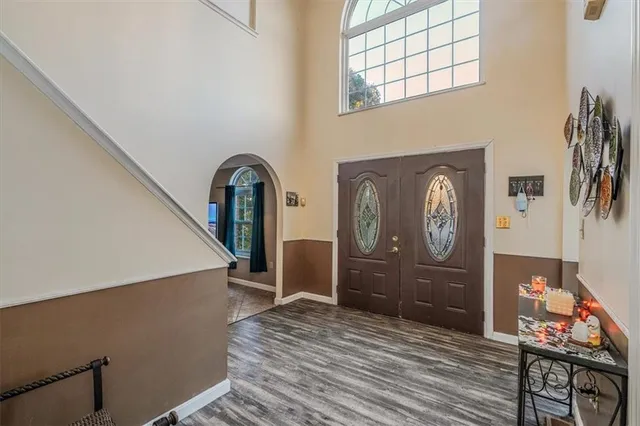 a view of a hallway with wooden floor and entryway