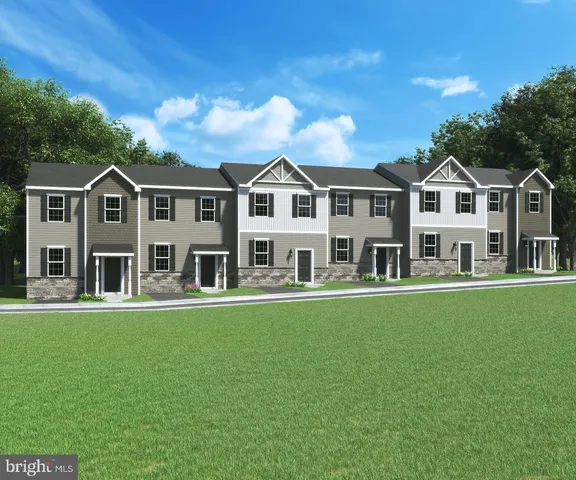 a front view of a house with a garden area