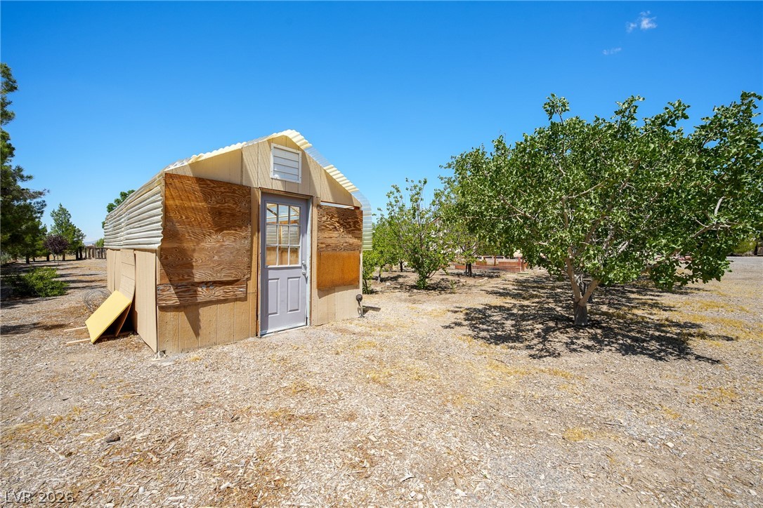 1831 West Horn Road Pahrump, NV 89048 - Photo 36 of 59 A quaint outbuilding with simple construction offers practical backyard storage or utility space.