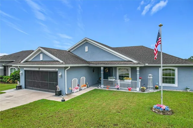 a front view of house with yard and outdoor seating